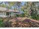 Backyard with mature trees, lush landscaping, and views of the home's screened-in patio at 3601 Galway Ln, Ormond Beach, FL 32174