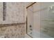 Bathroom featuring a shower with glass door and decorative starfish patterned wallpaper at 3601 Galway Ln, Ormond Beach, FL 32174