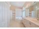 Relaxing bathroom featuring a soaking tub, walk-in shower, and a double sink vanity with marble countertops at 3601 Galway Ln, Ormond Beach, FL 32174