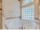 Close up of soaking tub area with glass block window feature at 3601 Galway Ln, Ormond Beach, FL 32174