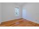 Bright bedroom with hardwood floors, a double closet, and a large window at 3601 Galway Ln, Ormond Beach, FL 32174