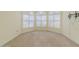Bedroom area featuring carpet flooring, natural light, and window shutters at 3601 Galway Ln, Ormond Beach, FL 32174