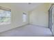 Spacious bedroom featuring neutral tones, carpet flooring, lots of natural light, and a sliding glass door at 3601 Galway Ln, Ormond Beach, FL 32174