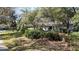 Front exterior view of a single story house with mature trees and lush landscaping at 3601 Galway Ln, Ormond Beach, FL 32174