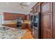 Gourmet kitchen featuring granite countertops, wooden cabinets, and stainless steel appliances at 3601 Galway Ln, Ormond Beach, FL 32174