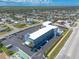 An aerial view of a condo with plenty of parking spaces, surrounding landscape, and close to the beaches of Florida at 3700 S Atlantic Ave # 413, New Smyrna Beach, FL 32169