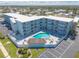 Aerial view of this lovely building with a pool and mature landscaping at 3700 S Atlantic Ave # 413, New Smyrna Beach, FL 32169
