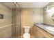 This bathroom features a glass enclosed shower, granite countertop vanity and sink, and a standard toilet at 3700 S Atlantic Ave # 413, New Smyrna Beach, FL 32169