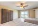 This bedroom features two beds, tile flooring, ceiling fan, and sliding door to the exterior balcony and ocean views at 3700 S Atlantic Ave # 413, New Smyrna Beach, FL 32169