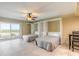 This bedroom features two beds, tile flooring, ceiling fan, and sliding door to the exterior balcony and ocean views at 3700 S Atlantic Ave # 413, New Smyrna Beach, FL 32169