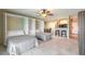 This bedroom features two beds, tile flooring, ceiling fan, and access to the kitchen and breakfast bar at 3700 S Atlantic Ave # 413, New Smyrna Beach, FL 32169