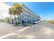 Full exterior view of Mariner's Cove showcasing parking and lush landscaping at 3700 S Atlantic Ave # 413, New Smyrna Beach, FL 32169