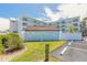 Beautiful exterior view of Mariner's Cove building with manicured lawn and parking at 3700 S Atlantic Ave # 413, New Smyrna Beach, FL 32169