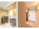 View of the kitchen area with bar seating and a dining table at 3700 S Atlantic Ave # 413, New Smyrna Beach, FL 32169