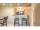 Compact kitchen area with bar seating and a dining table at 3700 S Atlantic Ave # 413, New Smyrna Beach, FL 32169