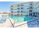 Beautiful community pool area with plenty of lounge chairs and sparkling, refreshing water at 3700 S Atlantic Ave # 413, New Smyrna Beach, FL 32169
