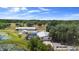 Areal view of a sprawling home with pool, workshop, and pond on lush acreage at 4145 Rambler Ave, St Cloud, FL 34772