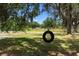 Inviting backyard with a tire swing hanging from a mature tree, creating a serene setting at 4145 Rambler Ave, St Cloud, FL 34772