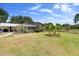Expansive backyard with a screened-in enclosure and lush greenery and banana trees at 4145 Rambler Ave, St Cloud, FL 34772