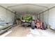 Spacious barn interior featuring a tractor and trailer on a concrete floor at 4145 Rambler Ave, St Cloud, FL 34772