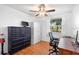Bedroom features hardwood floors, ceiling fan, and a large window with natural light at 4145 Rambler Ave, St Cloud, FL 34772