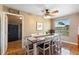 Dining room featuring a modern farmhouse table with seating for eight and brick accent wall at 4145 Rambler Ave, St Cloud, FL 34772