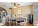 Bright and open dining area features a modern table, brick accent wall, and natural lighting at 4145 Rambler Ave, St Cloud, FL 34772