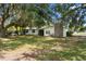 Charming single-story home with a stone chimney and beautiful mature trees in the front yard at 4145 Rambler Ave, St Cloud, FL 34772