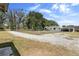Quaint home with a fenced yard and long drive amid mature trees and landscaping at 4145 Rambler Ave, St Cloud, FL 34772