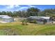 Spacious lawn surrounding a pool and auxiliary building on a sunny day at 4145 Rambler Ave, St Cloud, FL 34772