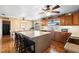 Open kitchen with island seating, a dining table, stainless appliances, and a 'Farmhouse' motif at 4145 Rambler Ave, St Cloud, FL 34772