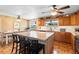 Kitchen and dining area with an island featuring bar stools, granite countertop and stainless appliances at 4145 Rambler Ave, St Cloud, FL 34772