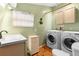 Laundry room with sink, washer and dryer, and custom tiled floor at 4145 Rambler Ave, St Cloud, FL 34772