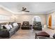 Open-concept living room with ceiling fan and view of the arched doorway at 4145 Rambler Ave, St Cloud, FL 34772