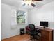 Office area with desk, wood look flooring and a window with a backyard view at 4145 Rambler Ave, St Cloud, FL 34772