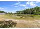 Scenic view of a tranquil pond surrounded by lush greenery and native plants at 4145 Rambler Ave, St Cloud, FL 34772