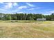 A sprawling green landscape with a picturesque pond and building structures at 4145 Rambler Ave, St Cloud, FL 34772