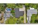 A bird's eye view of the property, showcasing the pool and surrounding trees at 44 Fairway Cir, New Smyrna Beach, FL 32168