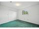A clean bedroom features a window with natural light, and a neutral color scheme at 44 Fairway Cir, New Smyrna Beach, FL 32168