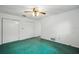 This bedroom has a fan, nice carpet, and a closet, providing a private area at 44 Fairway Cir, New Smyrna Beach, FL 32168