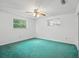 Bedroom with a fan and a window for natural light, providing a cozy retreat at 44 Fairway Cir, New Smyrna Beach, FL 32168