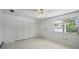 Bright bedroom with fan, closet, and an exterior window offering natural light at 44 Fairway Cir, New Smyrna Beach, FL 32168