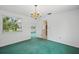 Well-lit dining room featuring a window and chandelier at 44 Fairway Cir, New Smyrna Beach, FL 32168