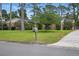 Charming home with a lush green lawn, mature trees, and a mailbox at the curb at 44 Fairway Cir, New Smyrna Beach, FL 32168