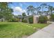 Charming brick home with a well-maintained lawn and mature landscaping at 44 Fairway Cir, New Smyrna Beach, FL 32168