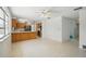 Eat-in kitchen with stainless refrigerator and appliances that flows into the living room space at 44 Fairway Cir, New Smyrna Beach, FL 32168