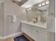 Contemporary bathroom with double sinks, bright vanity lighting and decorative flower vase at 4670 Links Village Dr # A506, Ponce Inlet, FL 32127