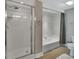 Clean bathroom featuring a glass-enclosed shower and a separate soaking tub at 4670 Links Village Dr # A506, Ponce Inlet, FL 32127