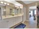 Bright bathroom boasting dual sinks, modern fixtures, and entry to the main bedroom at 4670 Links Village Dr # A506, Ponce Inlet, FL 32127