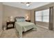 Cozy bedroom featuring a comfortable bed, nightstands, and a ceiling fan for added comfort at 4670 Links Village Dr # A506, Ponce Inlet, FL 32127